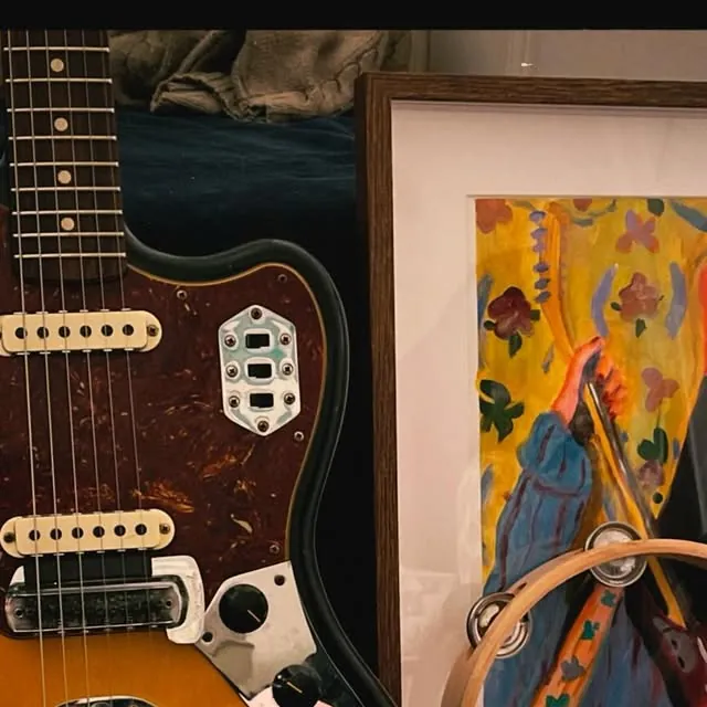 Painting beside guitar
